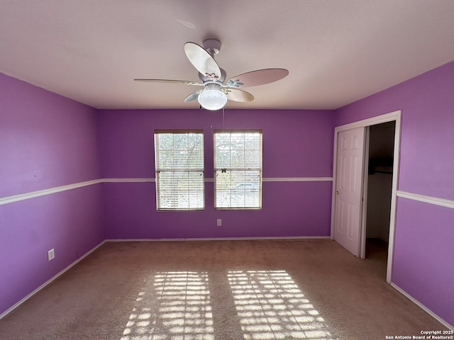 unfurnished bedroom with ceiling fan, carpet floors, and a closet