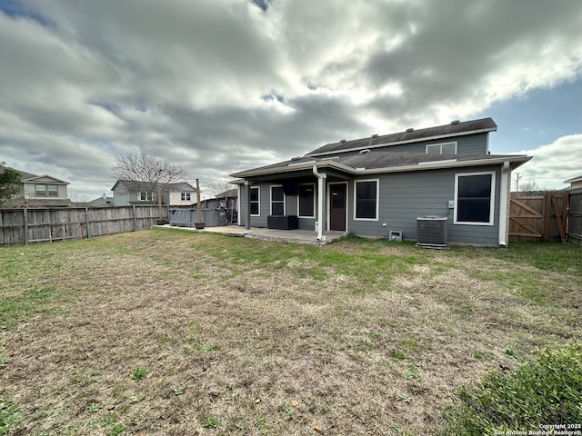 rear view of property with central AC, a yard, and a patio area