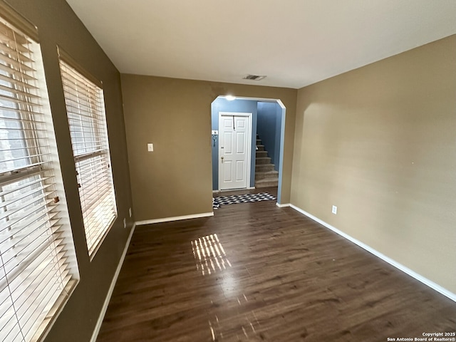 spare room featuring dark wood-type flooring