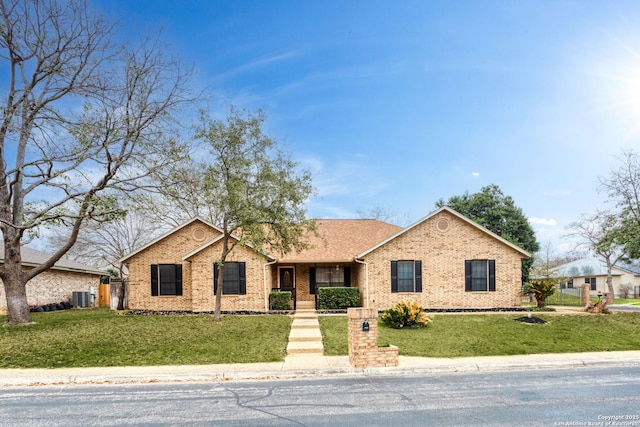 single story home with a front lawn and central air condition unit