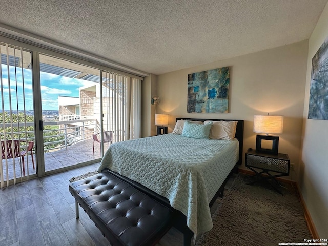 bedroom featuring hardwood / wood-style flooring, floor to ceiling windows, access to exterior, and a textured ceiling