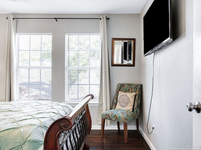 bedroom featuring dark wood-style floors and baseboards