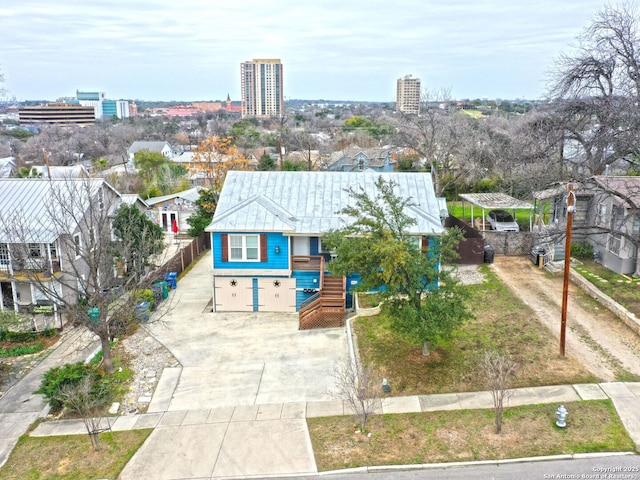 view of front of property with a view of city and driveway