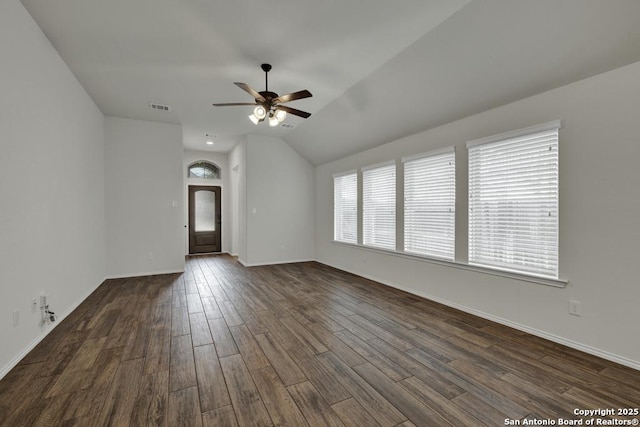 spare room with dark wood-type flooring, ceiling fan, and vaulted ceiling