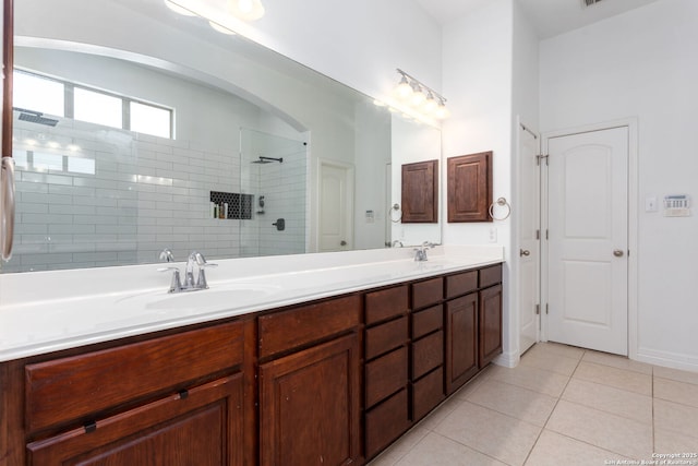 bathroom featuring vanity, tiled shower, and tile patterned floors