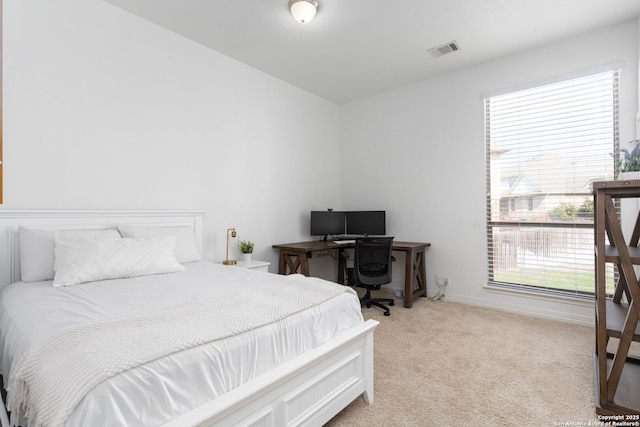 bedroom featuring light carpet