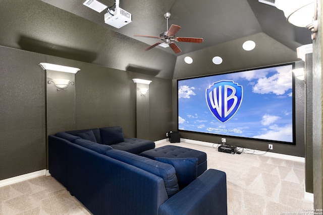 home theater room featuring light carpet, lofted ceiling, and ceiling fan