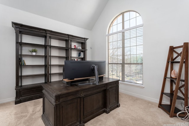 carpeted home office with lofted ceiling