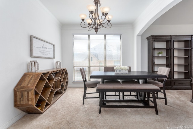 carpeted dining space featuring an inviting chandelier and ornamental molding