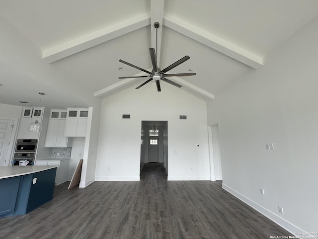 kitchen with light countertops, beamed ceiling, dark wood finished floors, and white cabinets