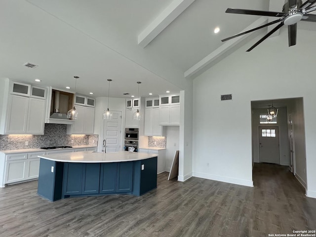 kitchen with gas stovetop, visible vents, a sink, and beamed ceiling