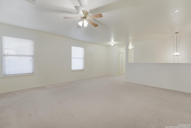 carpeted spare room with ceiling fan