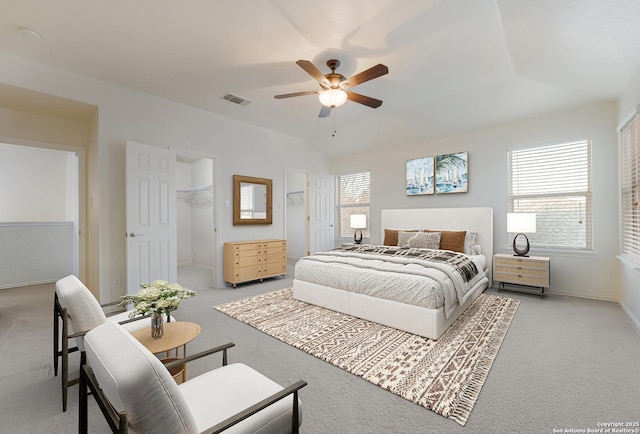 carpeted bedroom featuring a spacious closet and ceiling fan