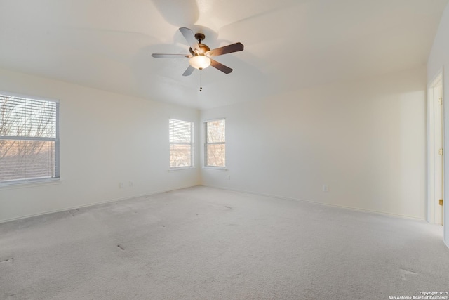 carpeted spare room featuring ceiling fan