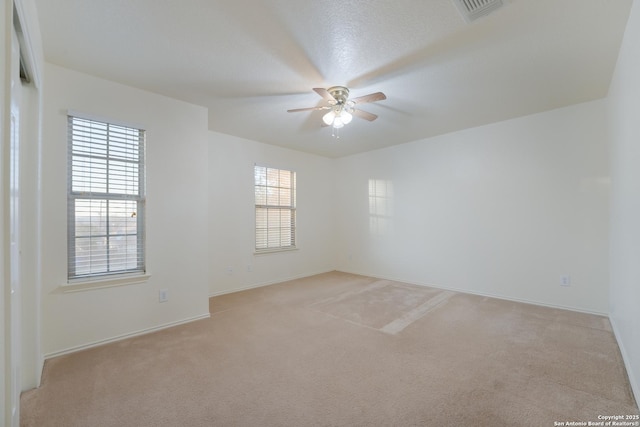 carpeted spare room with ceiling fan