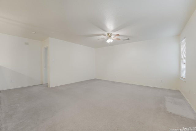 unfurnished room with light carpet and ceiling fan