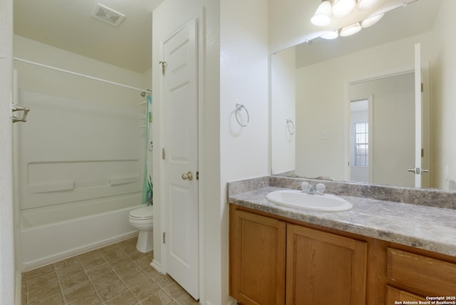 full bathroom with vanity, shower / bath combo, and toilet