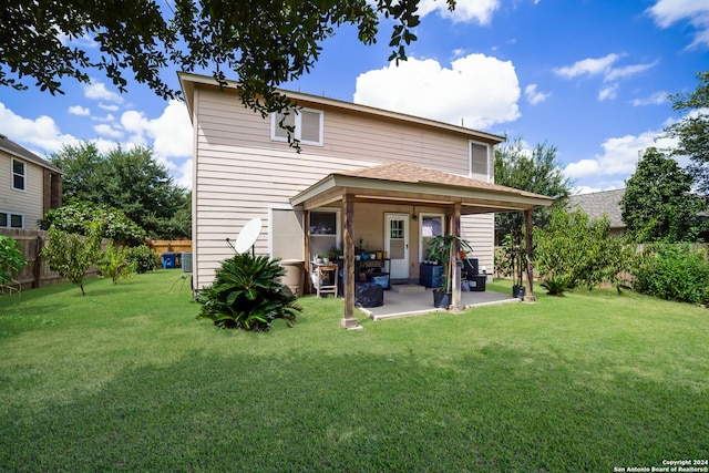 back of house featuring a patio and a lawn