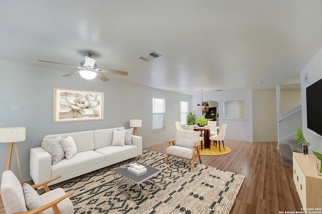 living room featuring hardwood / wood-style floors and ceiling fan