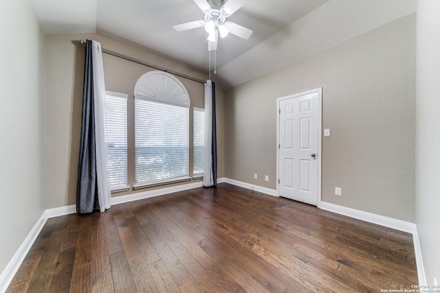 unfurnished room with lofted ceiling, dark hardwood / wood-style floors, and ceiling fan