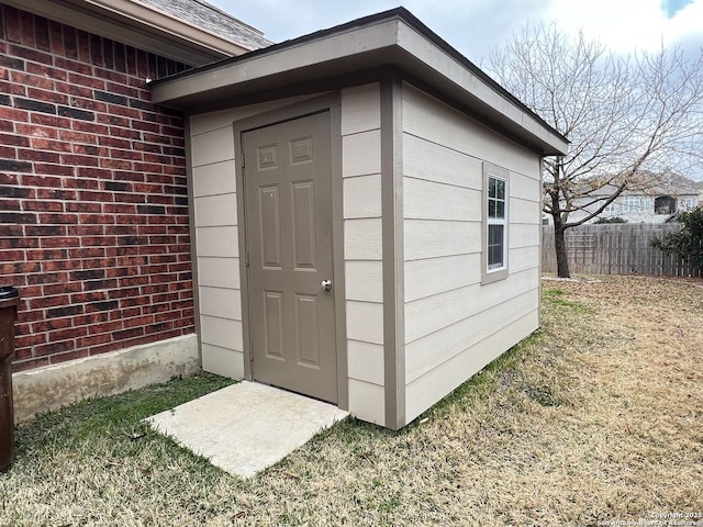 view of outbuilding featuring a lawn