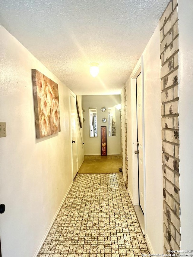 hallway featuring a textured ceiling