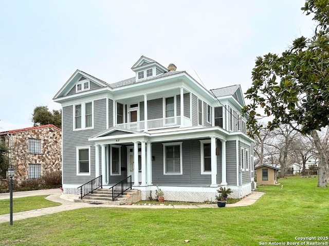 view of front of house with covered porch and a front lawn