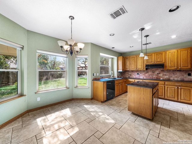 kitchen with sink, tasteful backsplash, decorative light fixtures, a kitchen island, and black appliances