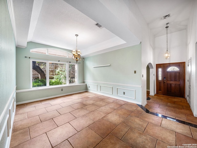 entrance foyer featuring lofted ceiling and a chandelier