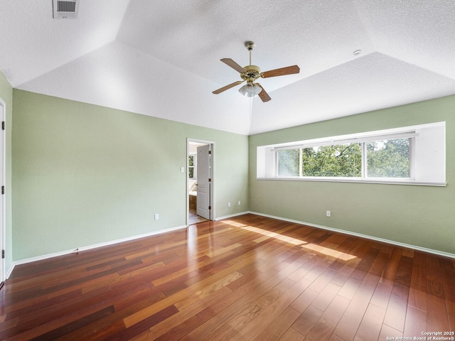 unfurnished room with vaulted ceiling, hardwood / wood-style floors, ceiling fan, and a textured ceiling