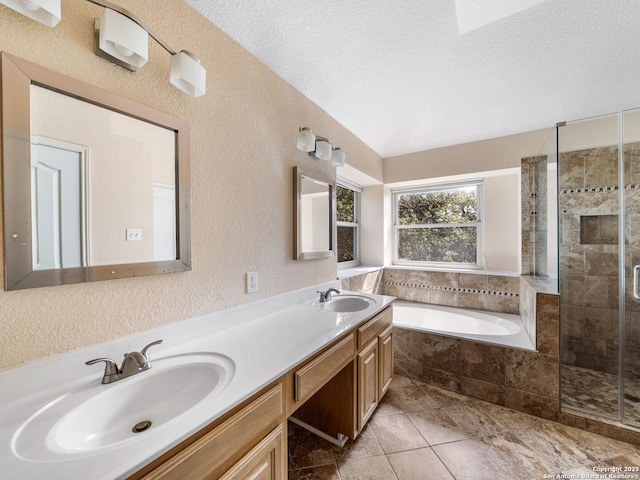 bathroom with vanity, tile patterned floors, independent shower and bath, and a textured ceiling