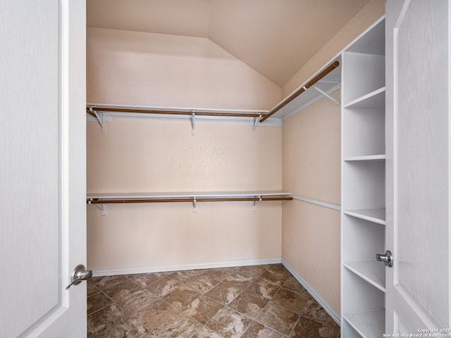 walk in closet featuring vaulted ceiling