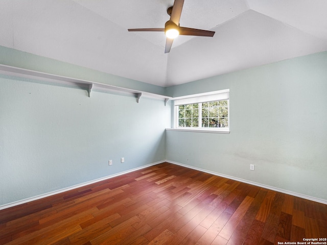 empty room with hardwood / wood-style flooring, ceiling fan, and lofted ceiling