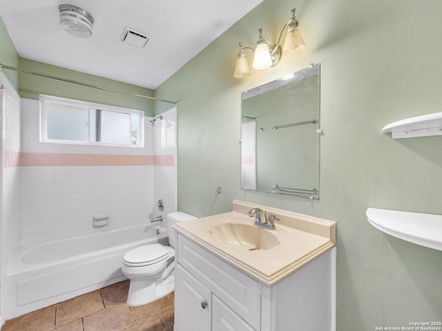 full bathroom with vanity, tiled shower / bath combo, tile patterned floors, and toilet