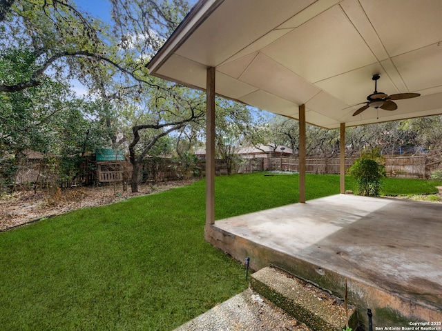 view of yard featuring a patio area and ceiling fan