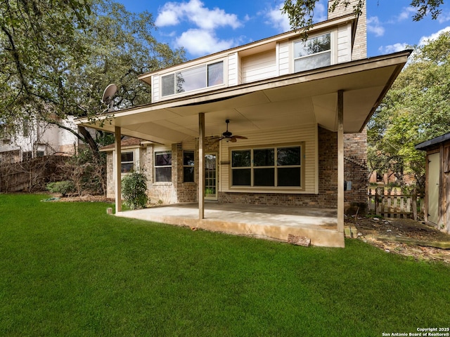 back of property with ceiling fan, a patio area, and a lawn