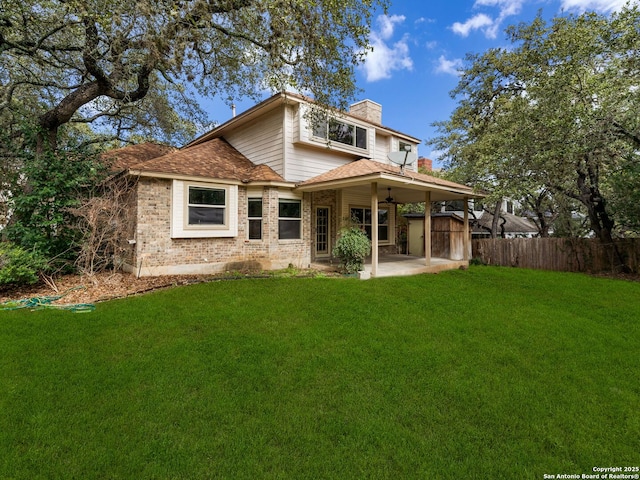 rear view of house featuring a yard, a shed, and a patio area