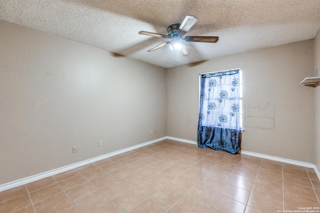 spare room with light tile patterned floors, a textured ceiling, and ceiling fan