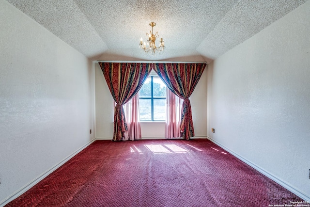 carpeted empty room featuring lofted ceiling, a notable chandelier, and a textured ceiling