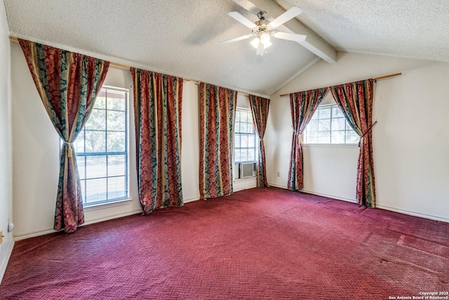 carpeted empty room with ceiling fan, vaulted ceiling with beams, and a textured ceiling