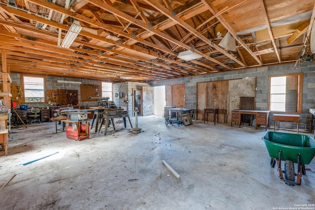 misc room with concrete flooring and a workshop area