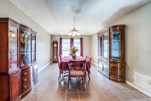 dining room with a notable chandelier, light tile patterned floors, vaulted ceiling, and a textured ceiling