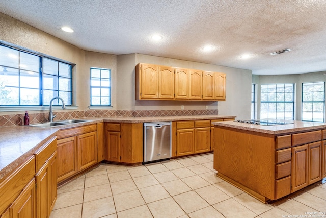 kitchen featuring sink, tasteful backsplash, light tile patterned floors, dishwasher, and black electric stovetop