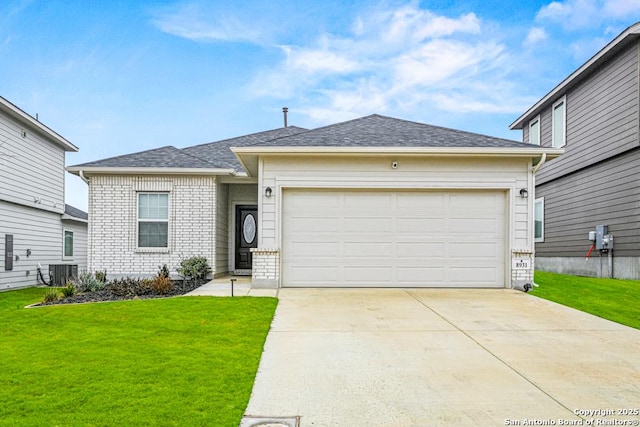 view of front of property with central AC, a garage, and a front lawn