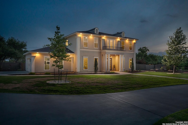 neoclassical / greek revival house with a balcony and stucco siding