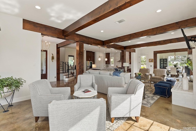 living area featuring a chandelier, beamed ceiling, recessed lighting, concrete flooring, and stairway