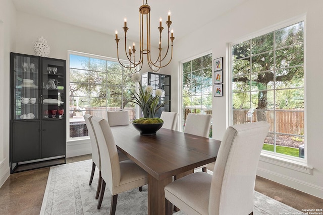 dining room featuring a chandelier and baseboards