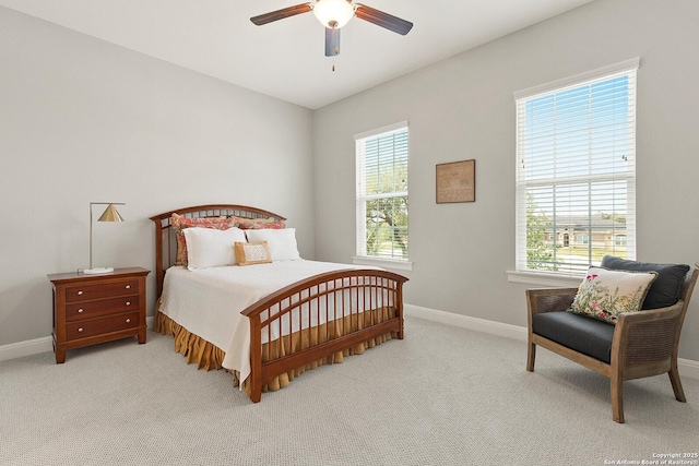 carpeted bedroom featuring baseboards and a ceiling fan