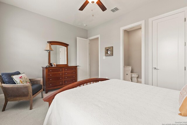 bedroom with carpet flooring, connected bathroom, a ceiling fan, and baseboards