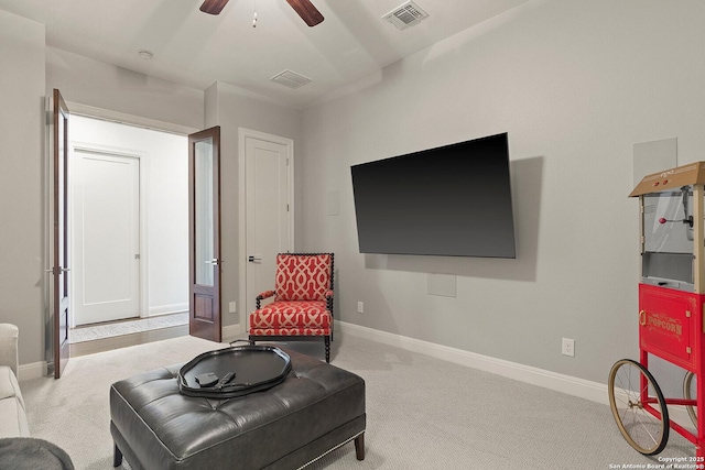 sitting room with ceiling fan, carpet flooring, and baseboards